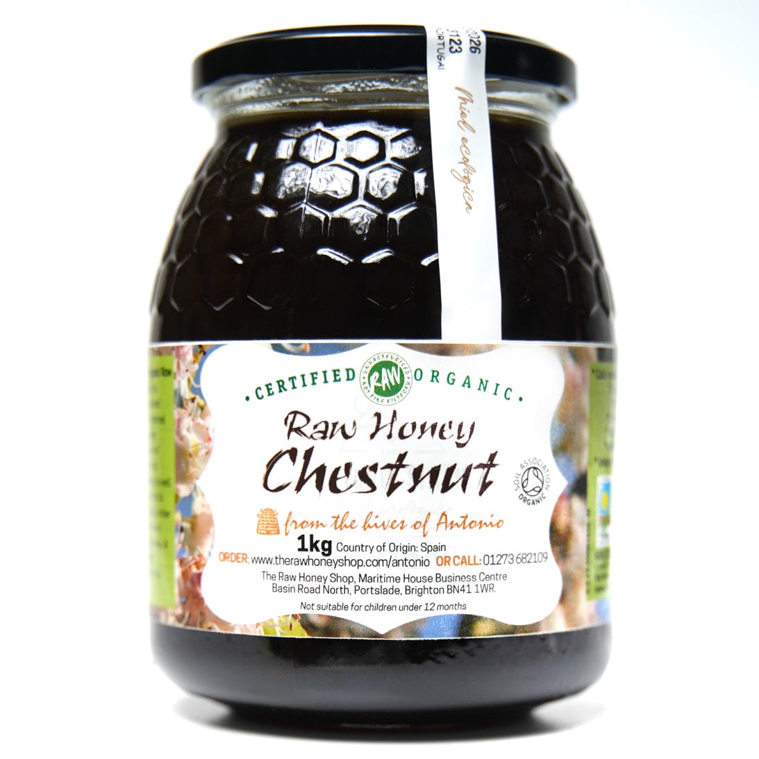 Jar of dark Chestut honey with white label to the front of the jar with the wording Raw Honey Chestnut.