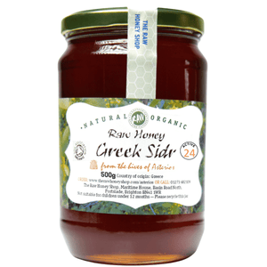 Jar of raw honey with a label on a white background