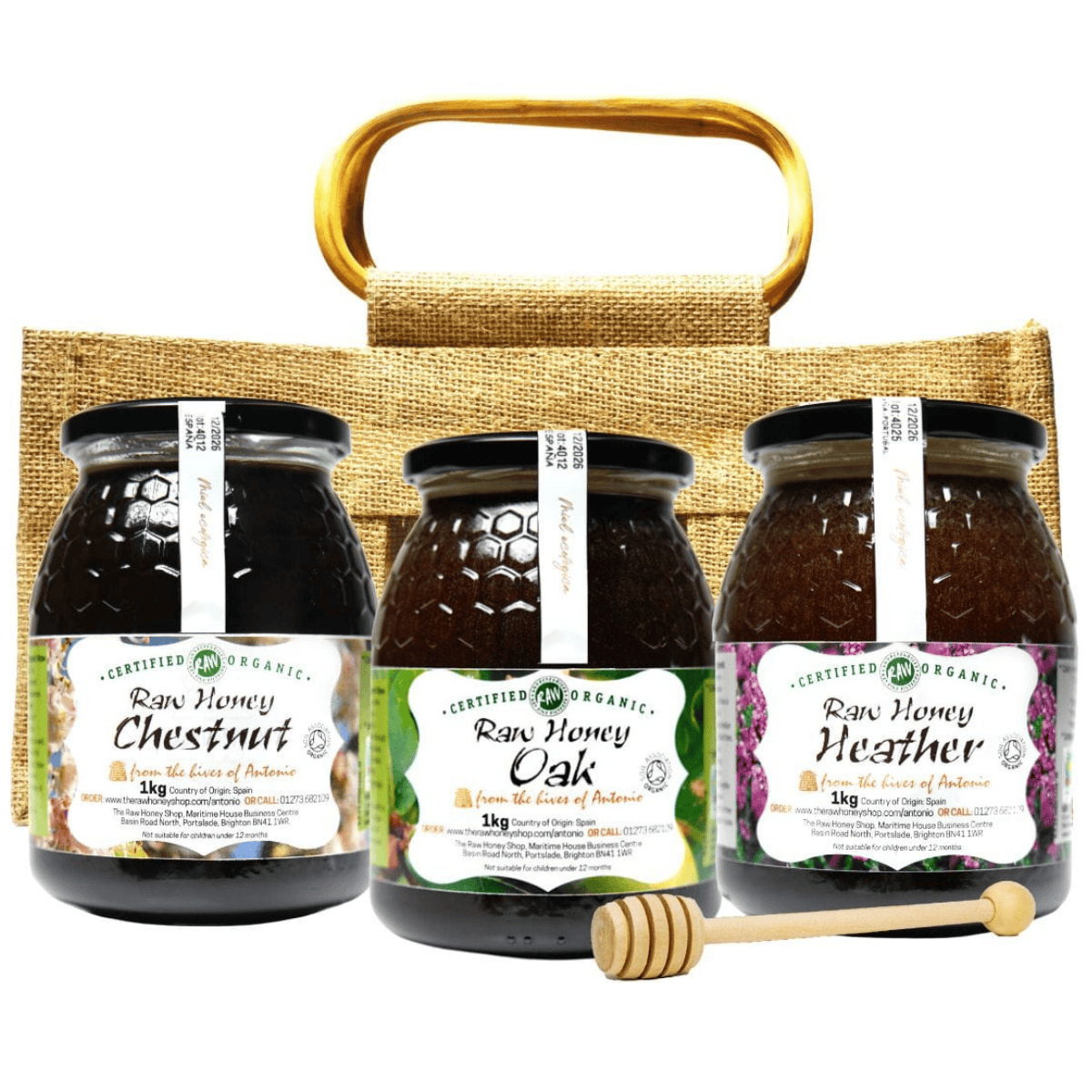 Three jars of raw honey with labels on a jute bag with a wooden handle.
