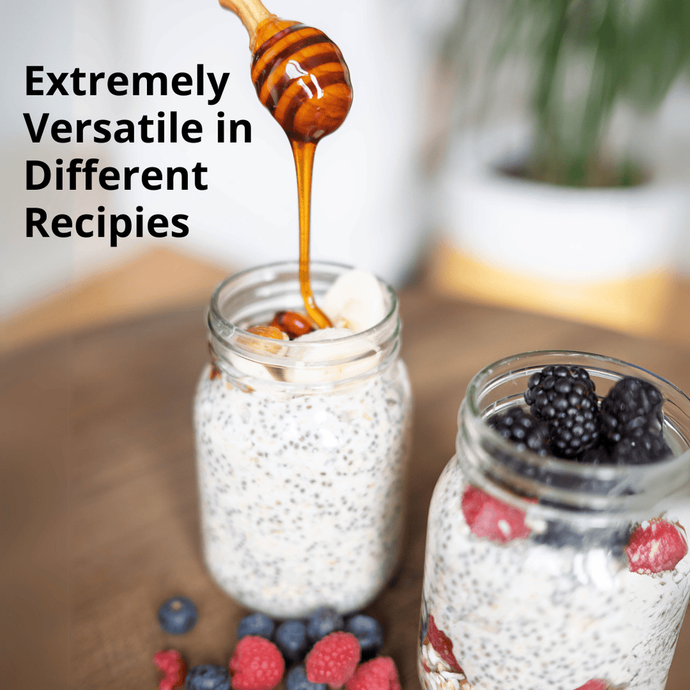 Two glass mason jars filled with overnight oats and berries on a wooden surface, with honey dripping from a wooden honey dipper into the jar. Text on the left reads 'Extremely Versatile in Different Recipes'.