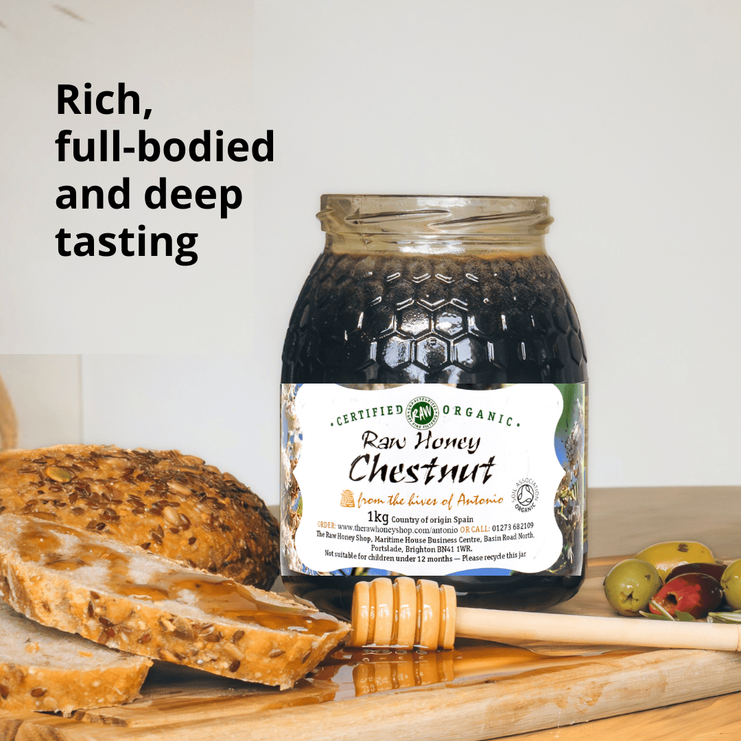 Jar of very dark brown honey labelthat reads raw honey chestnut with bread and olives.