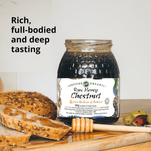 Jar of very dark brown honey labelthat reads raw honey chestnut with bread and olives.