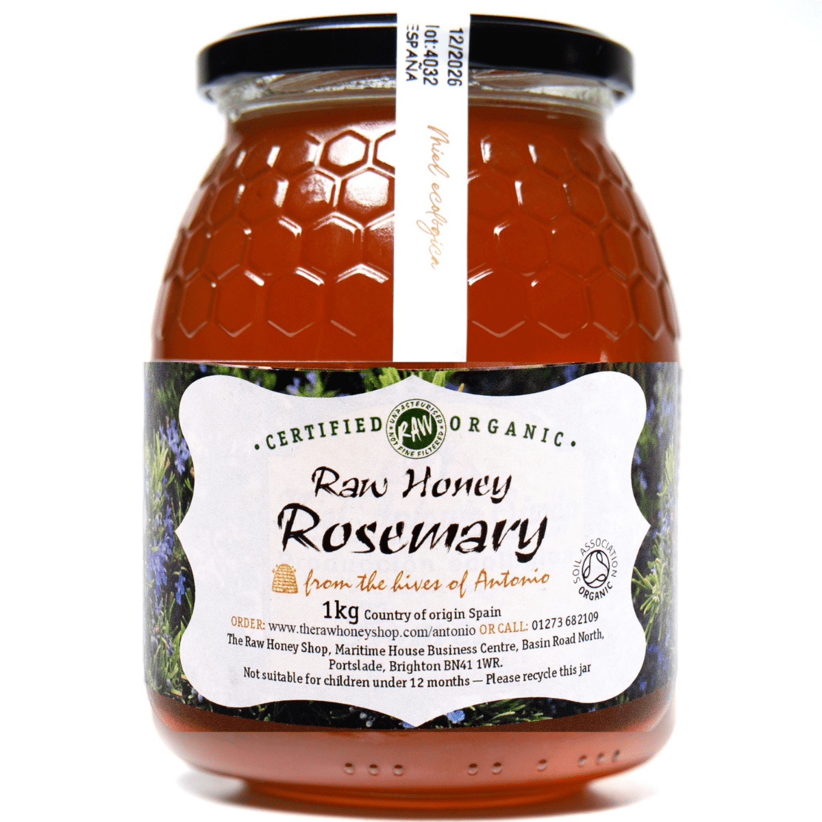 Jar of raw honey with rosemary flavor on a white background