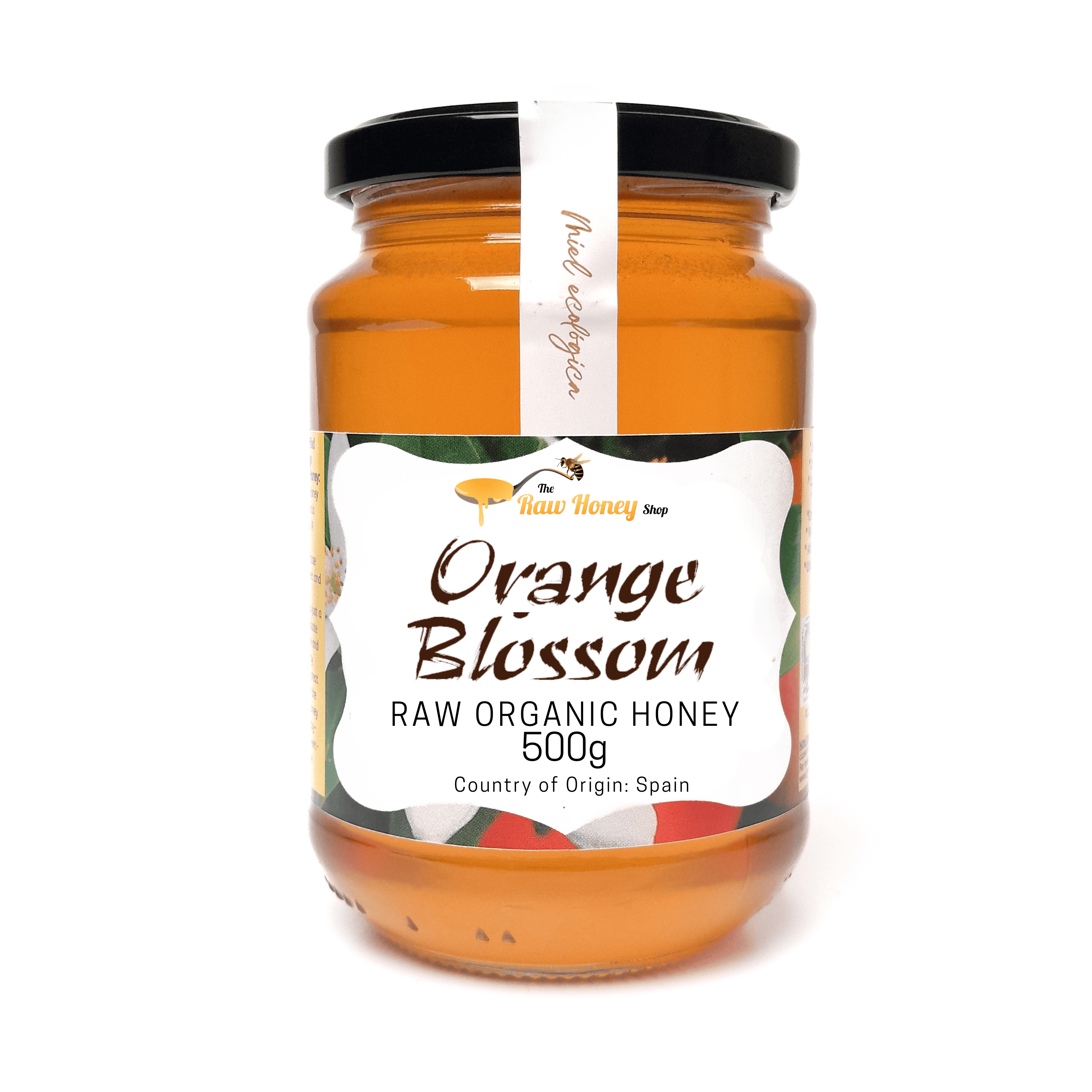A 500g glass jar of 'Antonios Raw Organic Orange Blossom' honey by 'The Honey Shop' with a black lid and a white label, set against a plain white background.