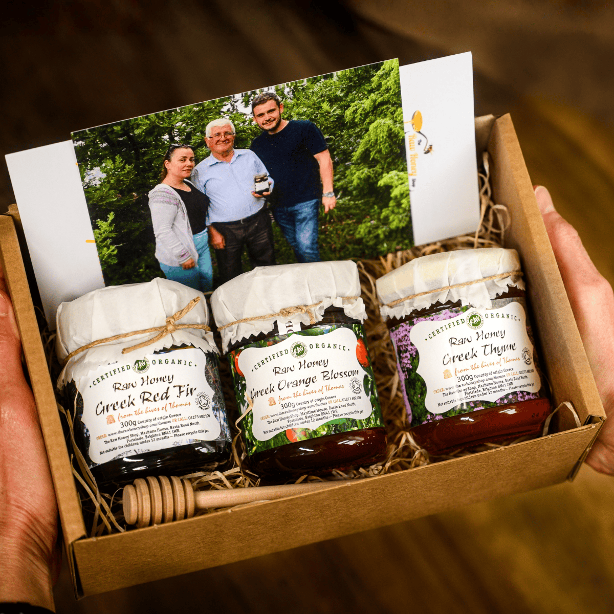 3 jars of honey in a gift box with photo of the beekeepers