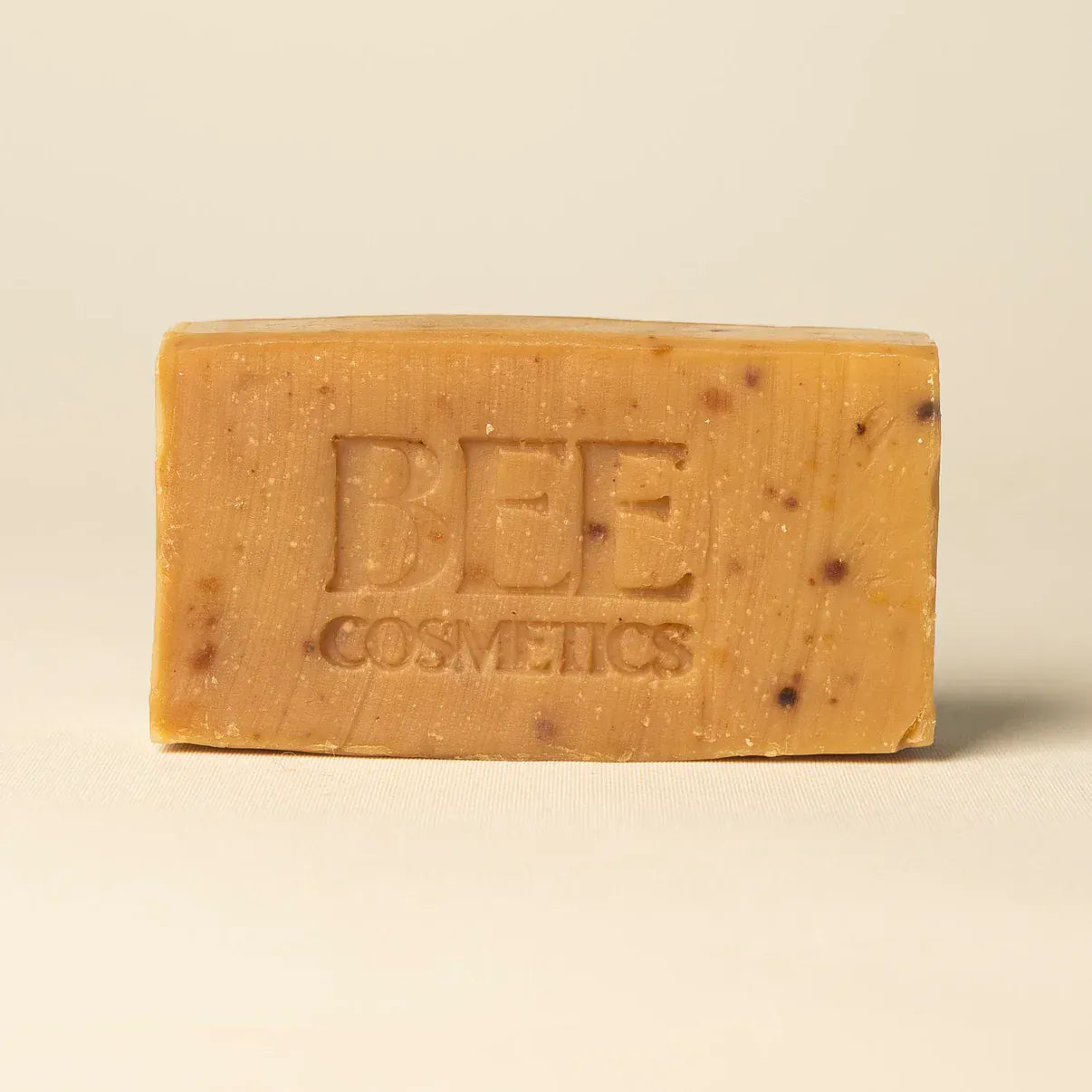 Bar of 'Bee Cosmetics' soap with stamped branding.