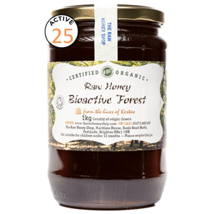 Jar of raw honey with a label on a white background