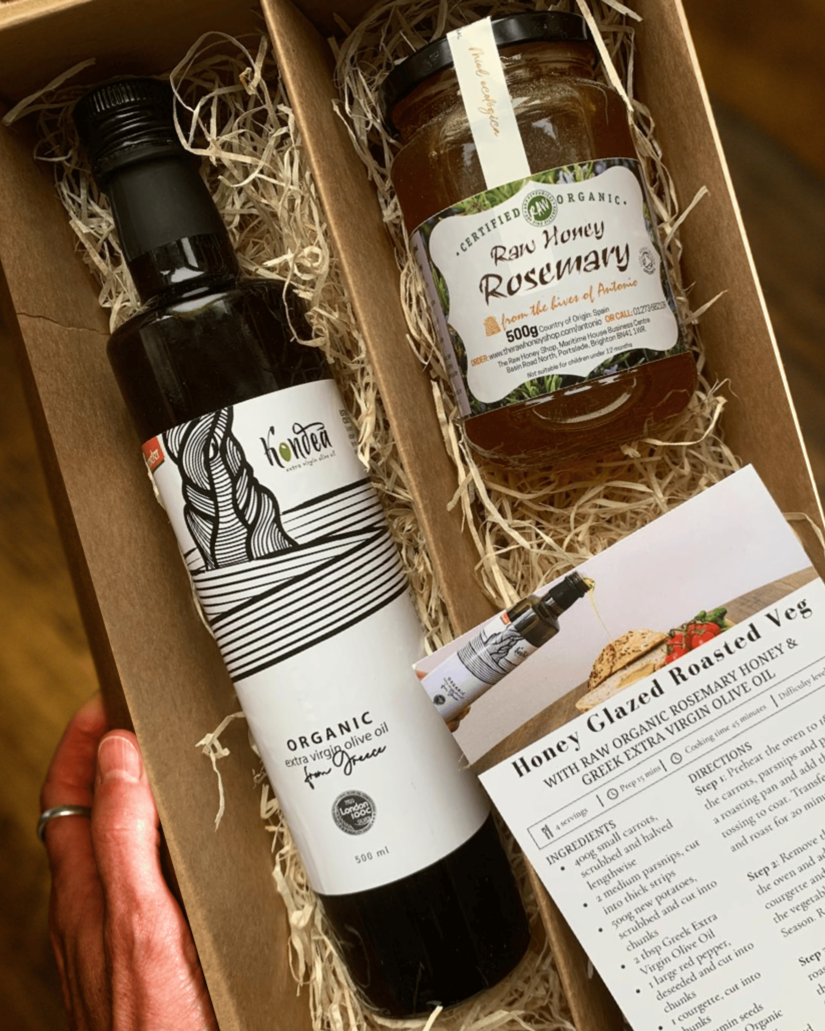 Gift set with olive oil, honey, and recipe card in a box