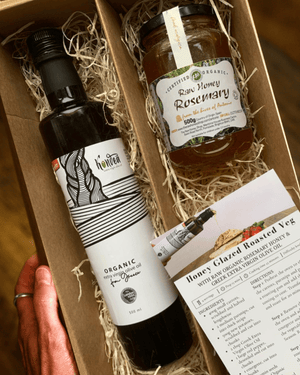 Gift set with olive oil, honey, and recipe card in a box