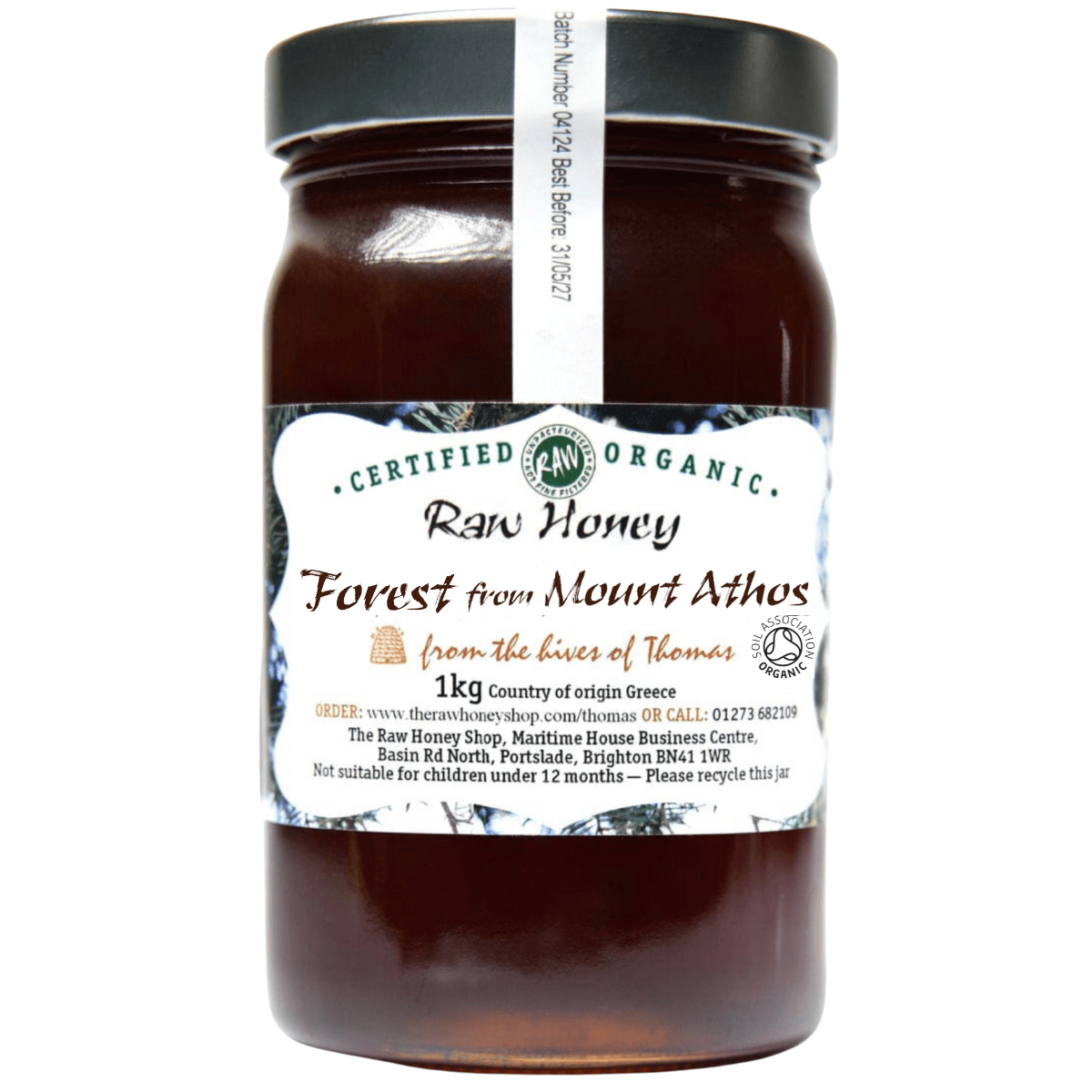 Dark brown honey in a glass jar with white label to front.