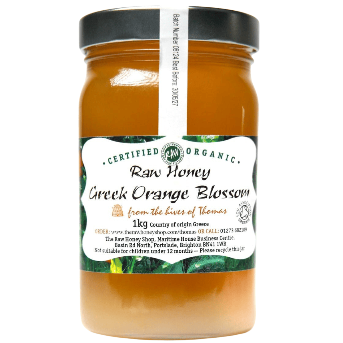 Orange coloured honey in a clear glass jar with white label to front.