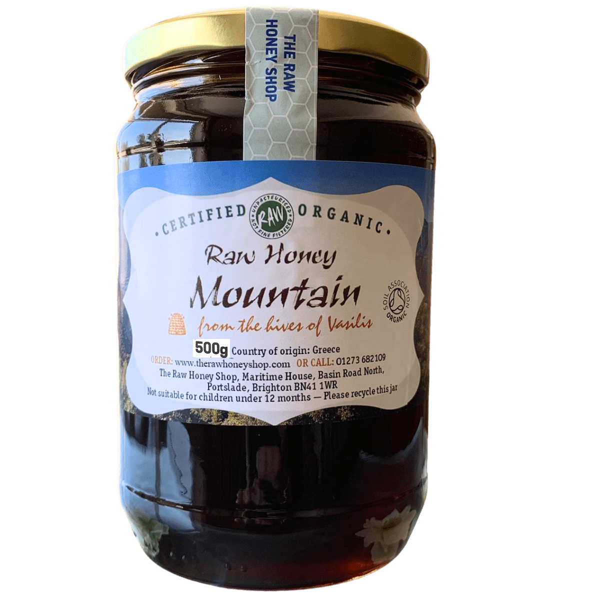 Jar of raw honey with a label on a white background