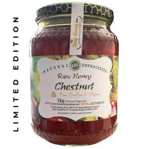 Chestnut brown honey in a glass jar with white label to front.
