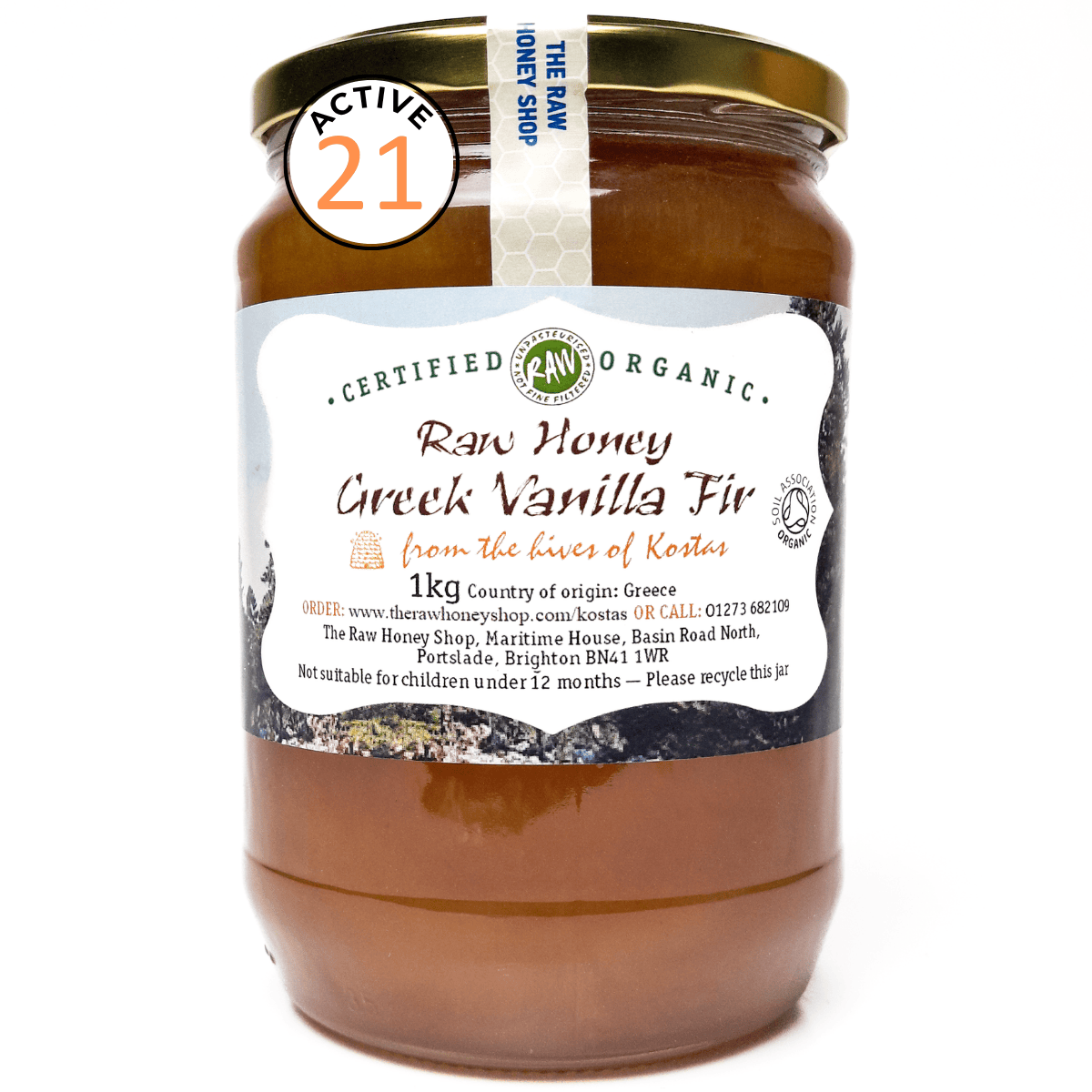 Jar of raw honey with a label on a white background
