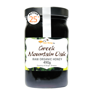 A jar of Native Honey Greek Mountain Oak Raw Organic Honey, 490g, with a black lid and a white label featuring green accents, set against a plain white background.
