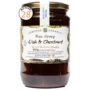 Jar of raw honey with 'The Raw Honey Shop' label on a white background