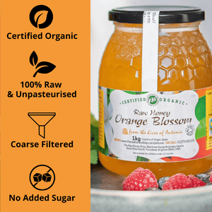 A jar of Certified Organic Raw Honey Orange Blossom honey shown next to an orange informational panel highlighting 'Certified Organic', '100% Raw & Unpasteurised', 'Coarse Filtered', and 'No Added Sugar'.