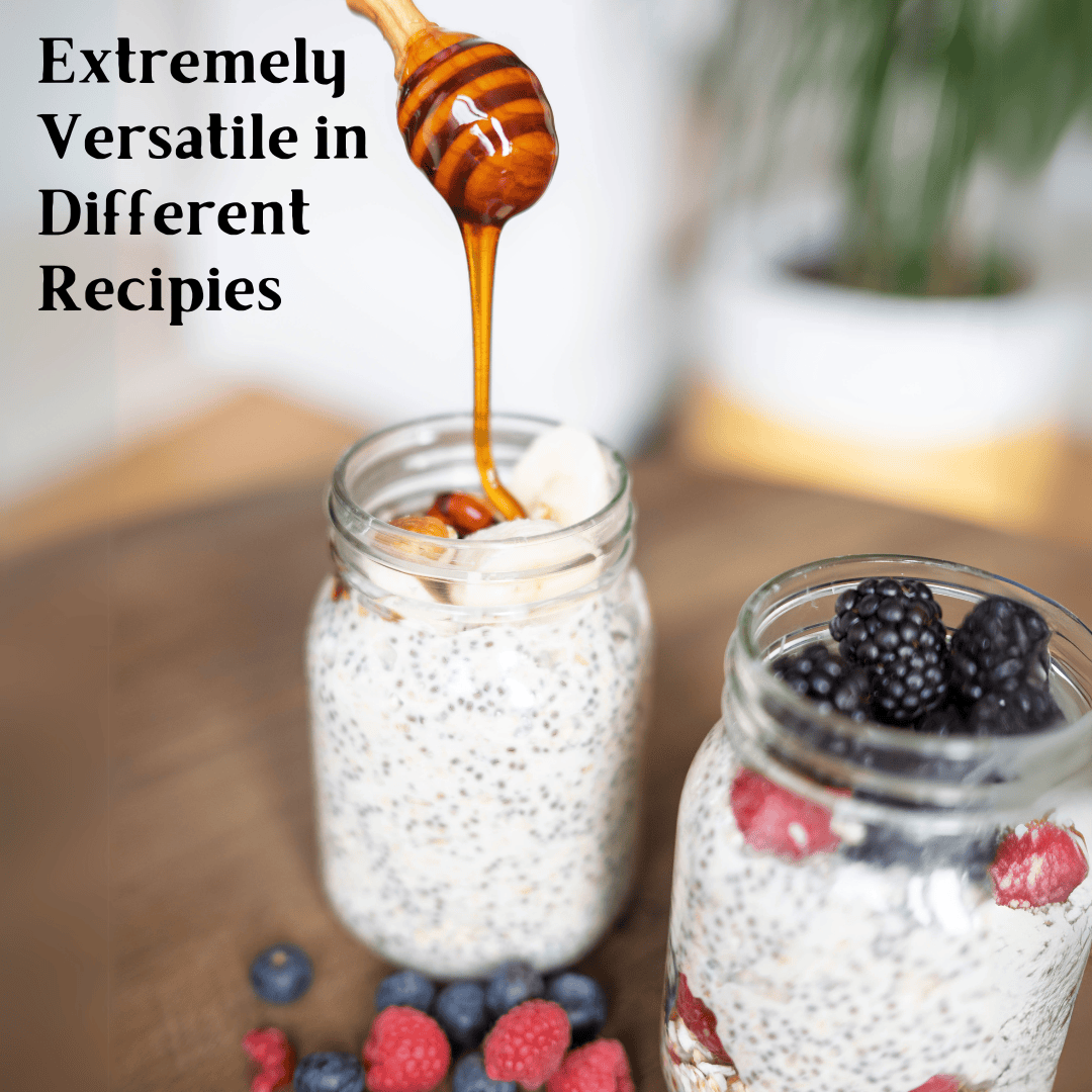 Two glass mason jars filled with overnight oats and berries on a wooden surface, with honey dripping from a wooden honey dipper into the jar. Text on the left reads 'Extremely Versatile in Different Recipes'.