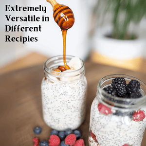 Two glass mason jars filled with overnight oats and berries on a wooden surface, with honey dripping from a wooden honey dipper into the jar. Text on the left reads 'Extremely Versatile in Different Recipes'.