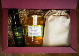 Gift box with a bottle of olive oil, jar of honey, and drawstring bag.