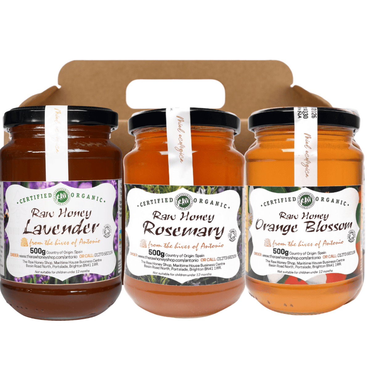 Three jars of raw honey with labels for Lavender, Rosemary, and Orange Blossom flavors in a cardboard holder.