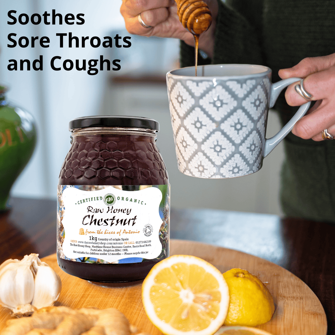 A jar of raw chestnut honey sits on a wooden board with a lemon half, garlic bulb, ginger piece, and a person pouring honey into a mug. Text on the image reads 'Soothes Sore Throat and Coughs'.