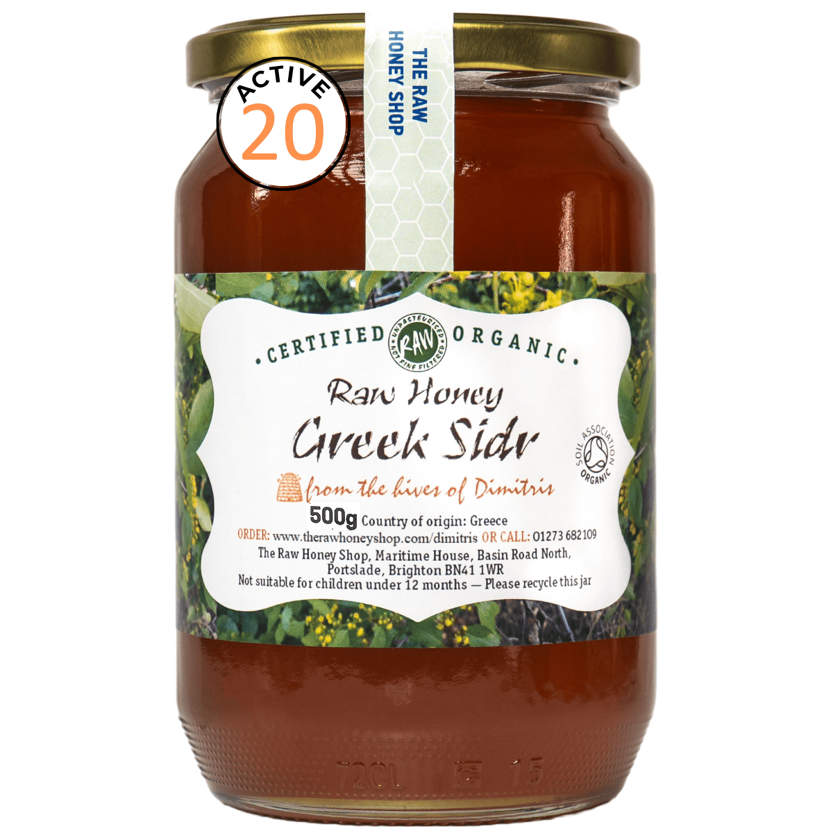 A 500g glass jar of The Raw Honey Shop Certified Organic Raw Honey Greek Sidr, featuring a white and green label with a gold metal lid, set against a plain white background.