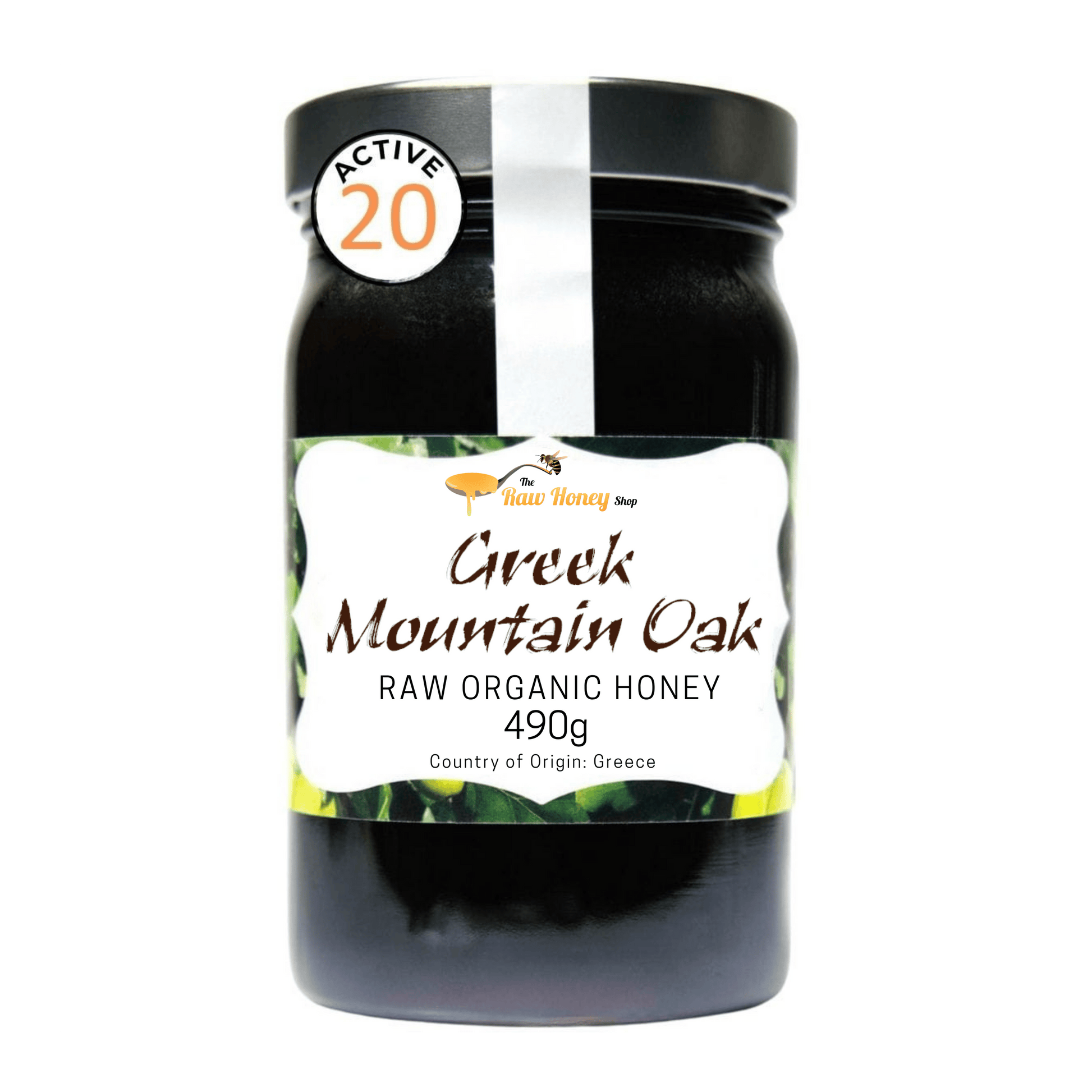 A jar of Greek Mountain Oak Raw Organic Honey from The Raw Honey Shop featuring a black lid, a white and green label, and an 'ACTIVE 20' seal on the upper left, set against a plain white background.