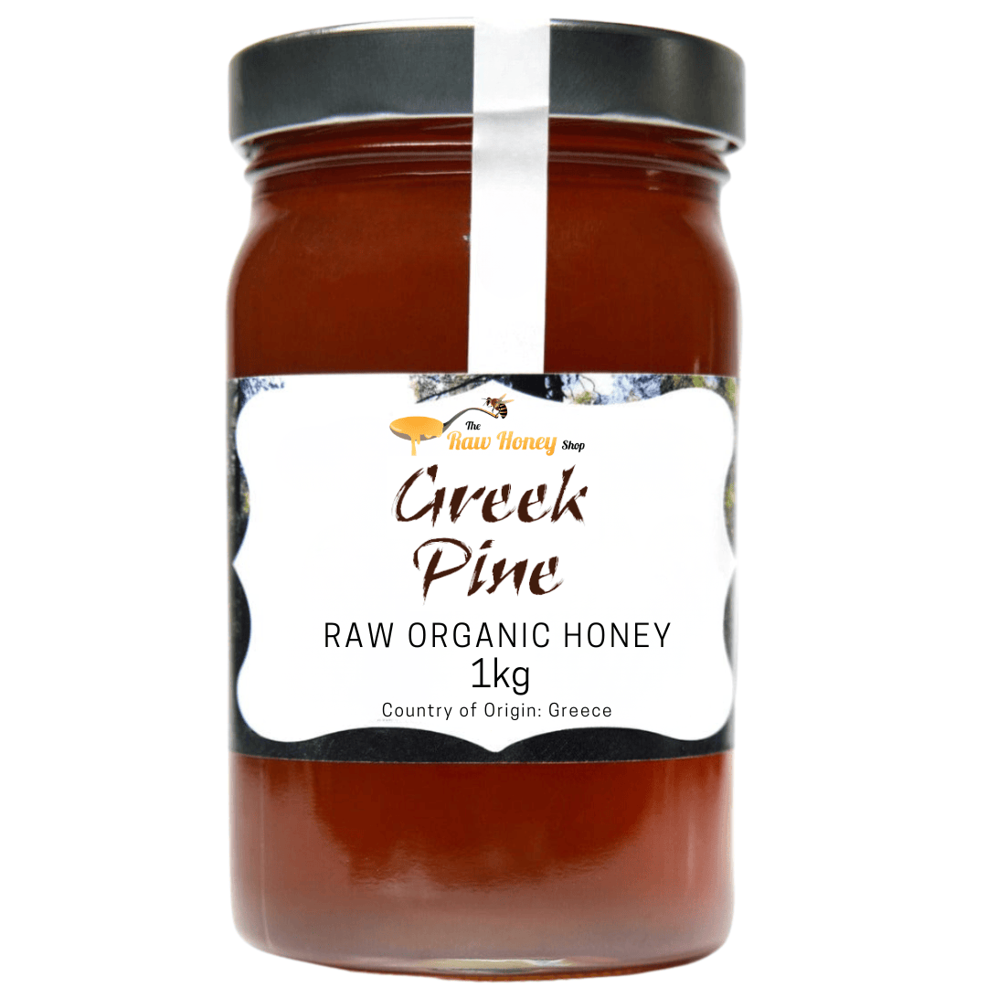 A 1kg glass jar of Thomas's Greek Pine Raw Organic Honey from The Raw Honey Shop with a black lid and a white label, shown against a plain white background.