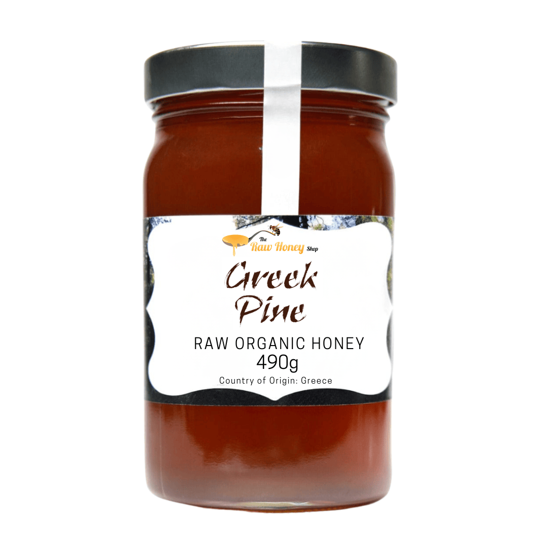 A 1kg glass jar of Thomas's Greek Pine Raw Organic Honey from The Raw Honey Shop featuring a white label with black text and a black lid, set against a plain white background.