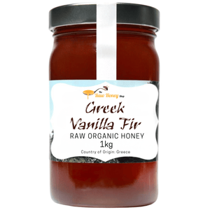 A 1kg glass jar of Thomas' Greek Vanilla Fir Raw Organic Honey by The Raw Honey Shop, featuring a white label with a black lid, set against a plain white background.