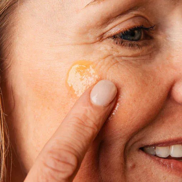 Close up of women applying 100% Natural Facial Cleansing Gel by Bee Cosmetics.