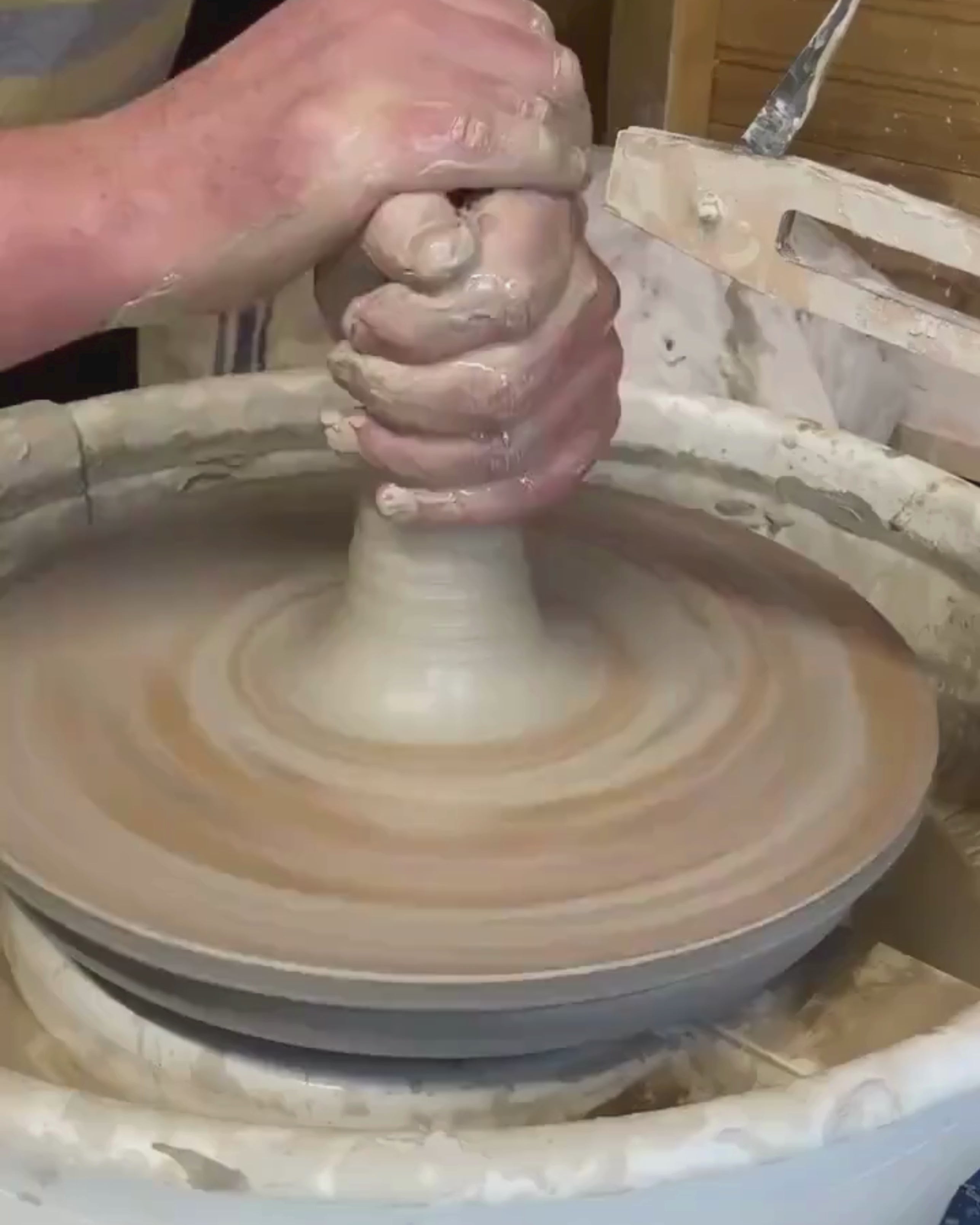 Video of man making a pot on a potters wheel.