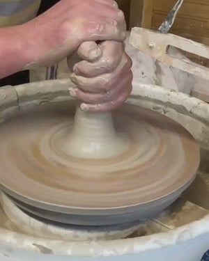 Video of man making a pot on a potters wheel.