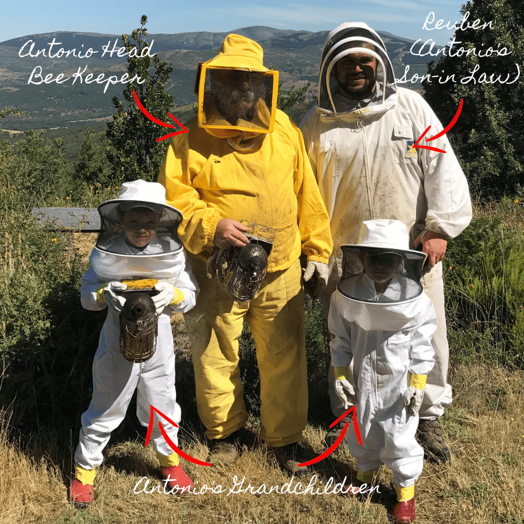 Beekeeper Antonio with Reuben his son in law and his two grandchildren all wearing beekeepers suits.