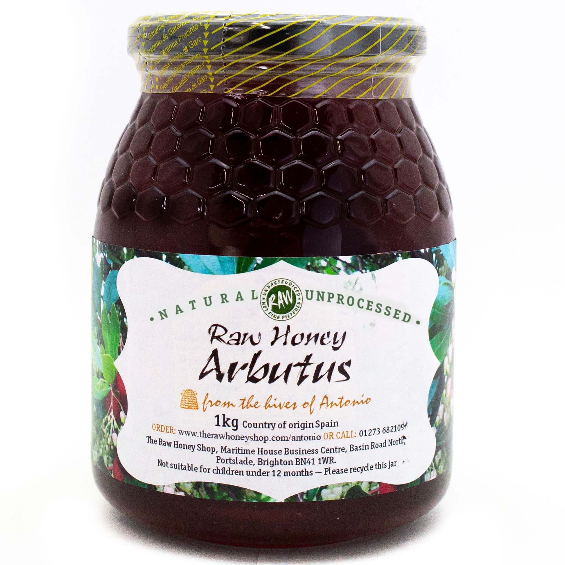 Large labelled glass jar containing 1kg of dark raw arbutus honey