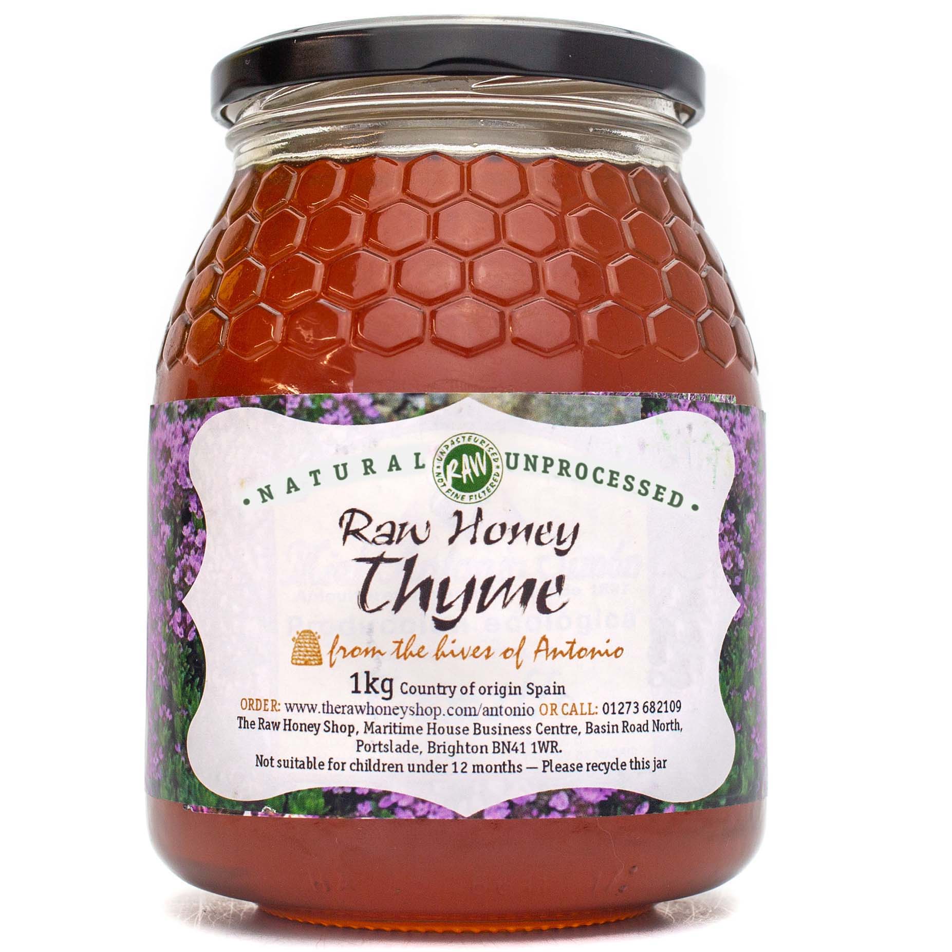 Large labelled glass jar containing 1kg of raw thyme honey.